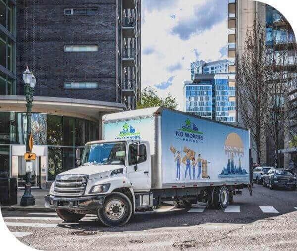 No Worries Moving truck on a sunny road with buildings around